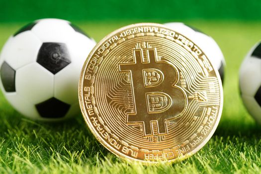 Gold bitcoin with soccer ball or football, cryptocurrency used in online sports betting.