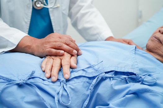 Doctor holding hands Asian elderly woman patient, help and care in hospital.