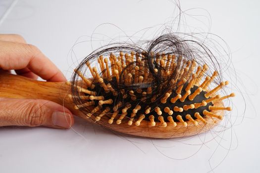 Hair loss fall with comb brush isolated on white background.