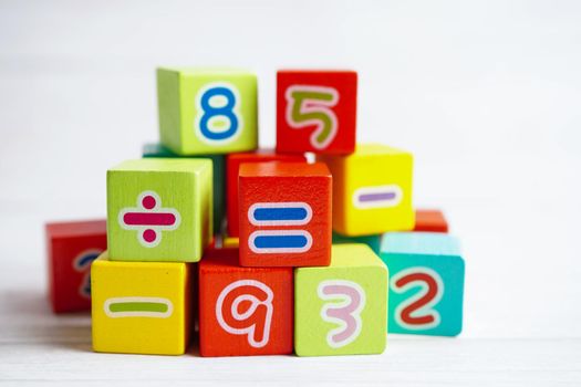 Number wood block cubes for learning Mathematic, education math concept.