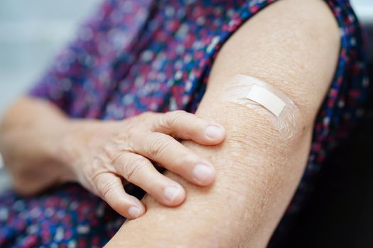 Asian elder senior woman patient getting coronavirus vaccine.