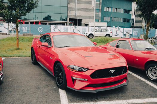 Genk, BELGIUM, August 18, 2021: classic summer meet of oldtimer at The Luminus Arena Genk, red Ford MustangHigh quality photo