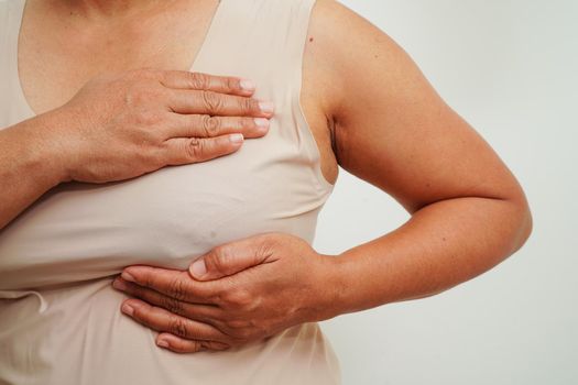 Asian woman self touching check lump or Breast cancer, Breast Self Exam.