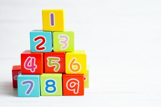 Number wood block cubes for learning Mathematic, education math concept.