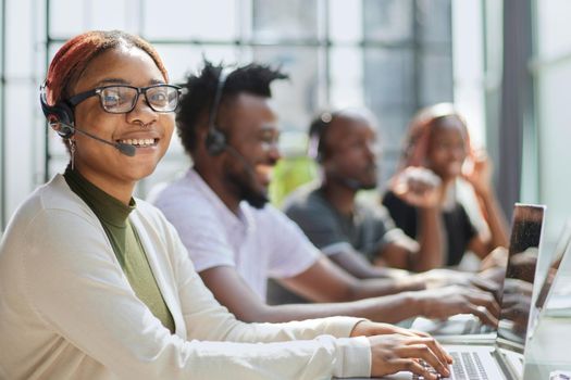 Call Center Operator With Colleagues At Workplace