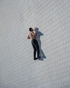 A man doing push-ups with flying outdoors