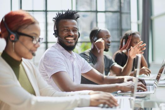 Call Center Operator With Colleagues At Workplace