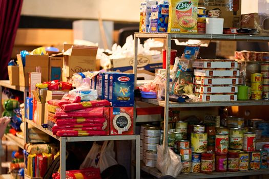 Canned food humanitarian aid for Ukraine in warehouse. Dnipro, Ukraine - 06.30.2022