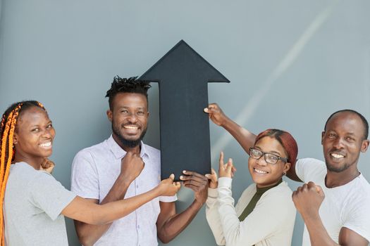 Business Team Holding black arrow together