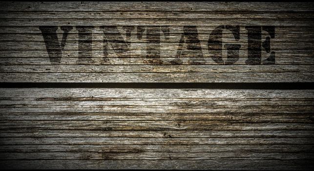 A stamp with the lettering Vintage on an old wooden background