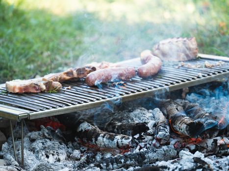 cooking pork meat in the grill outdoors with charcoal