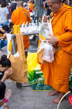 Bangkok, Thailand - October 24, 2016 : Unidentified thai monk ask for alms in morning for buddhist to make merit to offer food to the monks and receive blessing from the monks