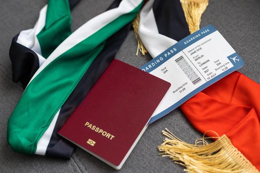 Passport and a United Arab Emirates flag on a gray background. Travel concept.