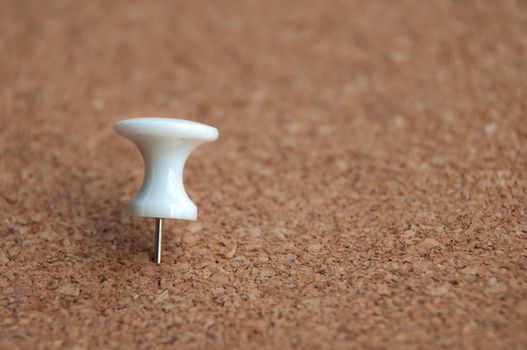 White push pins pinned on wooden background. Copy space