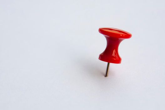 Red push pins isolated on white background. Copy space.