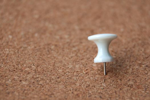 White push pins pinned on wooden background. Copy space