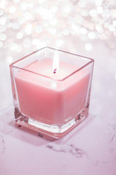 Festive decoration, branding and aromatherapy spa concept - Rose aromatic candle on Christmas and New Years glitter background, Valentines Day luxury home decor and holiday season brand design