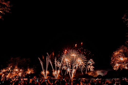 November 2019, Sukhothai Thailand. Group of people watching fireworks and using cellphones to record event in  river festival