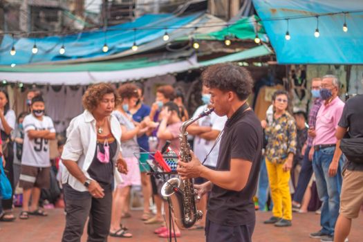 November 2020 Bangkok Thailand, Musicial playing  saxophone at Ongang canal street art.