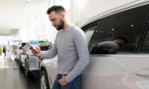 a man in a car dealership chooses a car and an insurance policy for it.