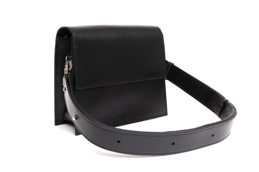 black rectangular women's leather bag with a belt.