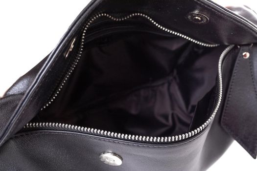 the insides of a women's bag made of genuine leather with many pockets and compartments.