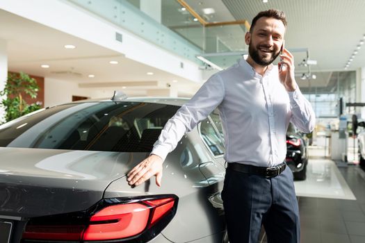 a man is happy about buying a new car and informs his family about it by phone.