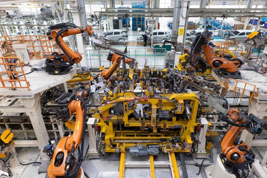Car bodies are on assembly line. Factory for production of cars. Modern automotive industry. Top view.