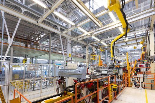 Photo of automobile production line. Welding car body. Modern car assembly plant. Auto industry.