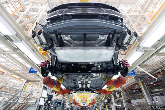 Automobile production line. Welding car body. Modern car assembly plant. Auto industry. Interior of a high-tech factory, modern production.