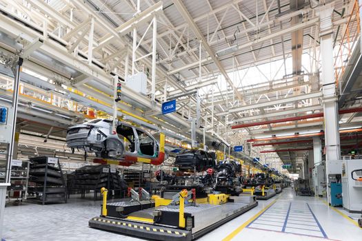 Photo of automobile production line. Welding car body. Modern car assembly plant. Auto industry. Interior of a high-tech factory, modern production.