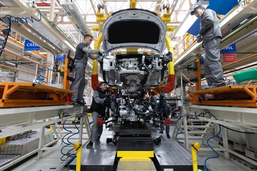 Minsk, Belarus - Dec 15, 2021: Automobile production line. Welding car body. Modern car assembly plant. Auto industry. Interior of a high-tech factory, modern production.