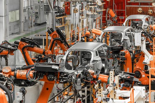 Photo of automobile production line. Modern car assembly plant. Modern and high-tech automotive industry.