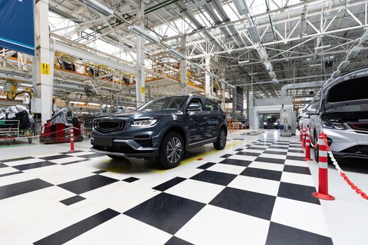 Modern car assembly plant. Auto industry. Interior of a high-tech factory, modern production of automobiles.