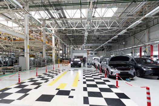 Modern car assembly plant. Auto industry. Interior of a high-tech factory, modern production of automobiles.