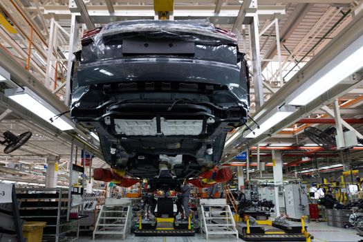 Minsk, Belarus - Dec 15, 2021: Automobile production line. Modern car assembly plant. Interior of a high-tech factory, manufacturing.