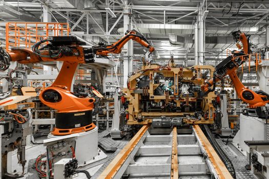 Photo of automobile production line. Welding car body. Modern car assembly plant. Auto industry.