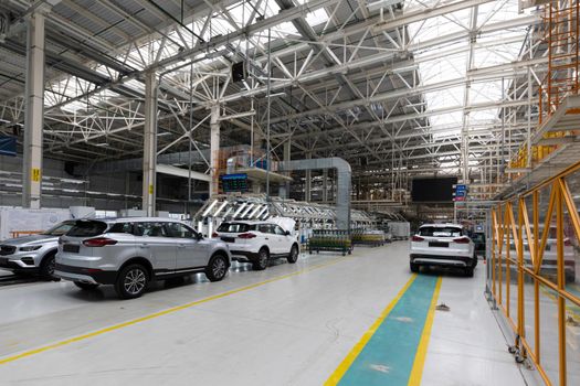 Automobile production line. Modern car assembly plant. Interior of a high-tech factory, manufacturing.