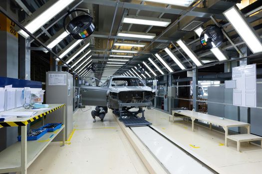 Car bodies are on assembly line. Factory for production of cars. Modern automotive industry.