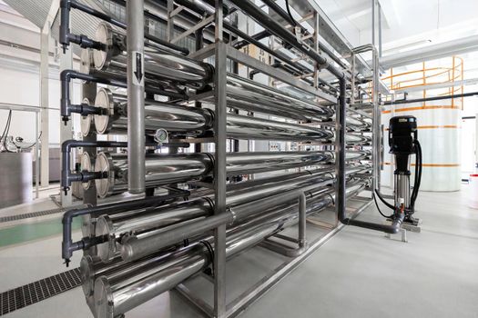 Photo of grey metal pipes and tanks. Chemistry and medicine production. Pharmaceutical factory.