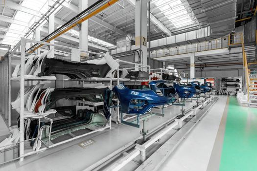 Photo of a warehouse with shelves with spare parts for cars and automobiles.