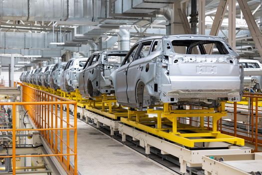Photo of automobile production line. Welding car body. Modern car assembly plant. Auto industry. High-tech factory.