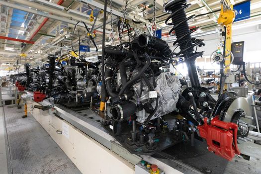 Photo of automobile production line. Welding car body. Modern car assembly plant. Auto industry. Interior of a high-tech factory, modern production.