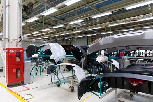 Photo of automobile production line. Welding car body and parts. Modern car assembly plant. Auto industry.