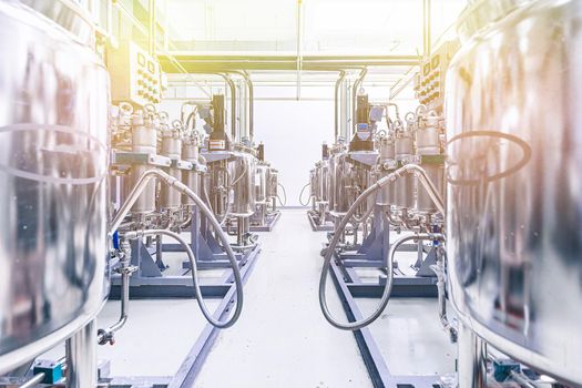 Photo of pipes and tanks. Chemistry and medicine production. Pharmaceutical factory. Interior of a high-tech plant, modern production. Yellow tone.