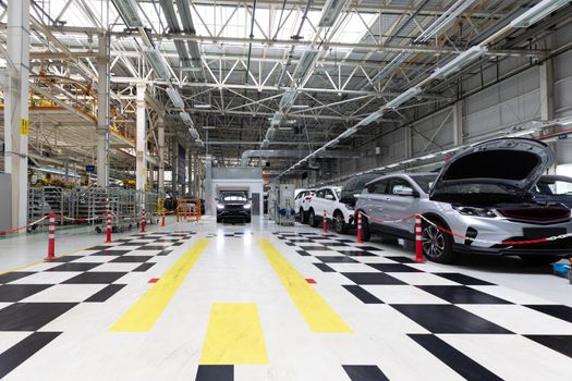 Modern car assembly plant. Auto industry. Interior of a high-tech factory, modern production of automobiles.