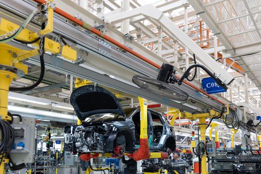 Minsk, Belarus - Dec 15, 2021: Car bodies are on assembly line. Factory for production of cars. Modern automotive industry. A car being checked before being painted in a high-tech enterprise.