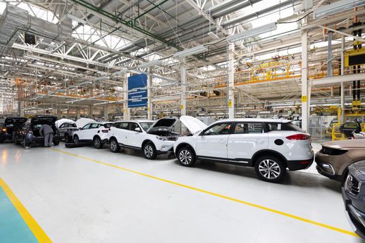 Modern car assembly plant. Auto industry. Interior of a high-tech factory, modern production of automobiles.