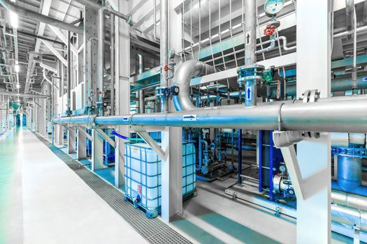 Photo of pipes and tanks. Chemistry and medicine production. Pharmaceutical factory. Interior of a high-tech factory, modern production. Blue tone.
