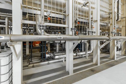 Photo of pipes and tanks. Chemistry and medicine production. Pharmaceutical factory. Interior of a high-tech factory, modern production.